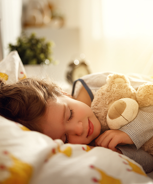 child asleep in bed